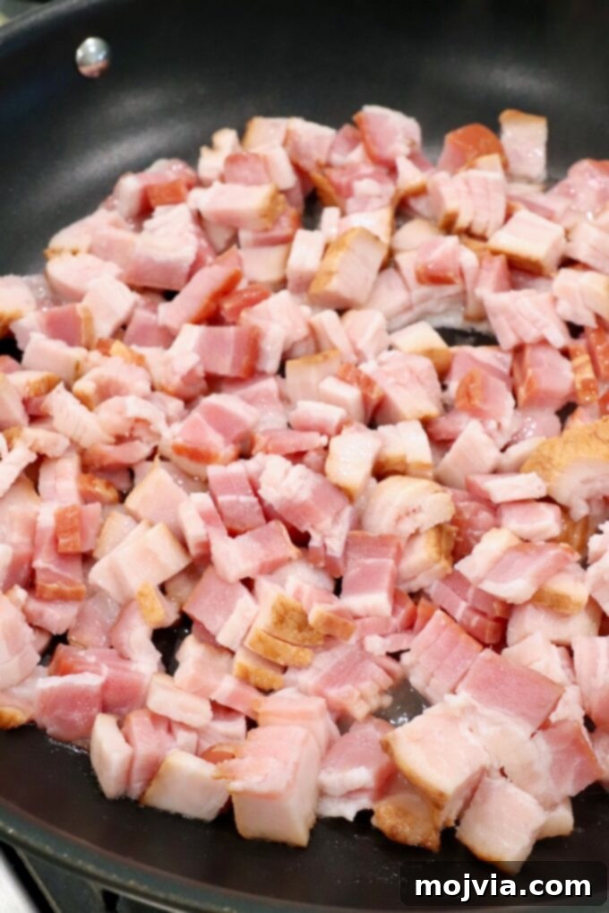 Sweet & Savory Bacon Preserve 4 Diced uncooked thick-cut bacon in a large skillet, ready to be cooked.