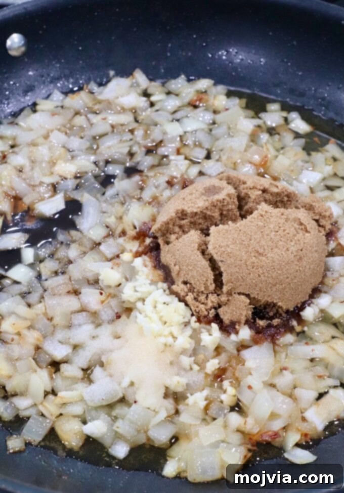 Sweet & Savory Bacon Preserve 8 Brown sugar, minced garlic, and salt added to the caramelized diced onions in the skillet.