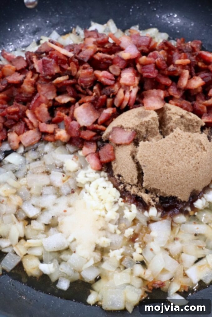 Sweet & Savory Bacon Preserve 9 All ingredients combined in the skillet: diced cooked bacon, caramelized onions, brown sugar, garlic, maple syrup, and apple cider vinegar.