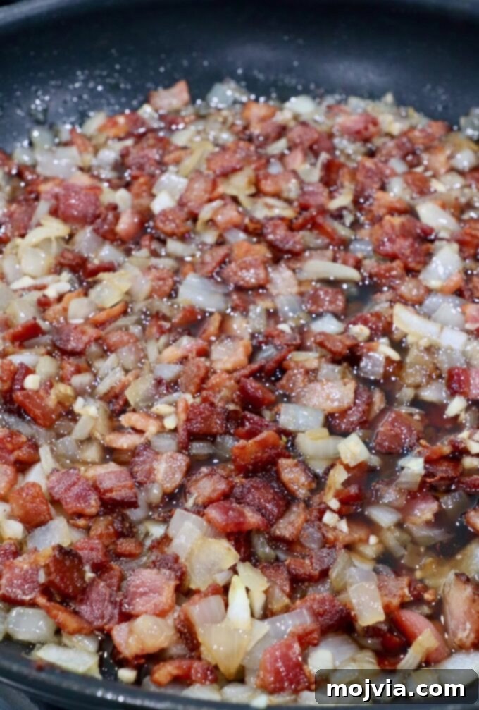 Sweet & Savory Bacon Preserve 10 A close-up of the cooked bacon and onion mixture simmering in the skillet, starting to thicken.