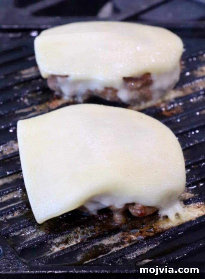 California Dream Burger 6 Cheese melting on burger patties on the grill pan
