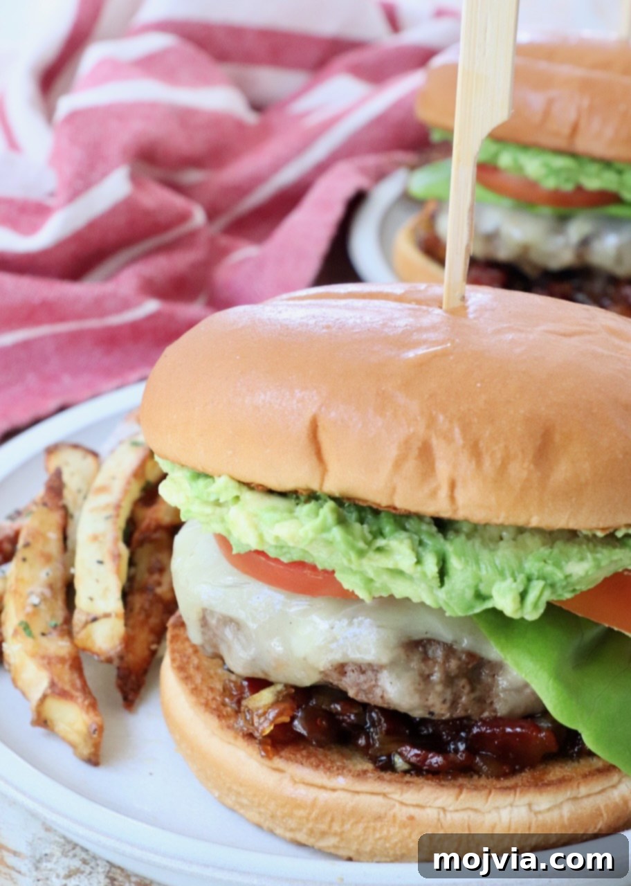 California Dream Burger 8 A fully assembled California Burger on a plate with truffle fries