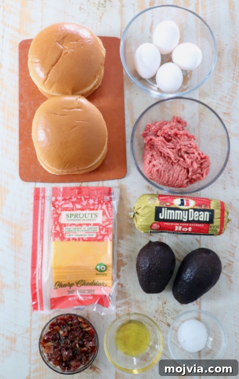 Sunrise Burger 3 Fresh ingredients laid out on a white wooden board, including ground beef, sausage, avocados, eggs, cheese, and buns, ready for making breakfast burgers.