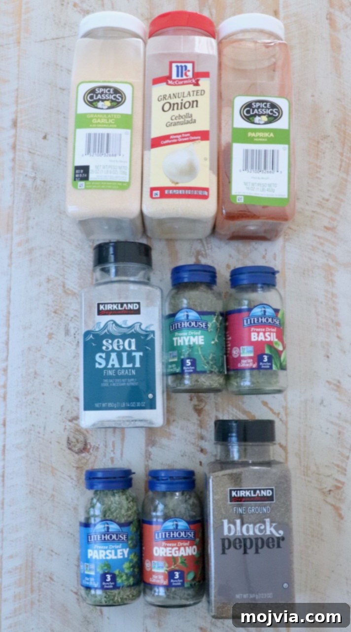 A beautifully arranged display of fresh ingredients for homemade vegetable seasoning on a rustic white wood board.