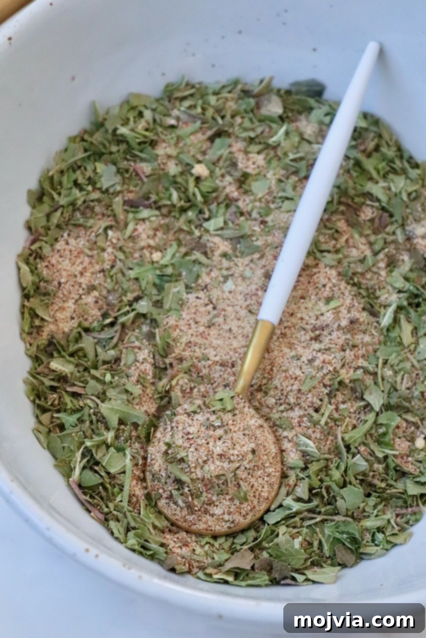 The vibrant homemade vegetable seasoning, perfectly mixed and presented in a bowl with a spoon, ready for use.