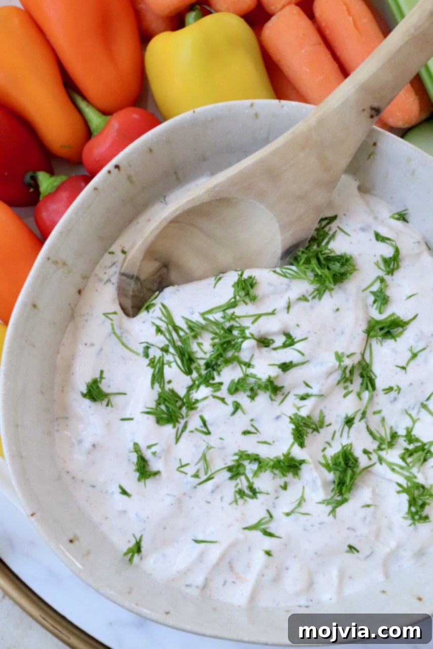 Garden Vegetable Dip 2 creamy dip in bowl topped with fresh chopped dill
