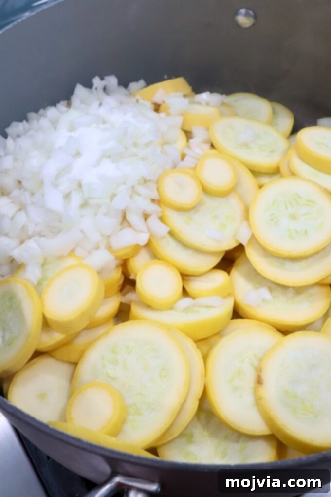 Golden Cheesy Squash Bake 4 Sliced yellow squash and diced onions beginning to sauté in a large skillet with melted butter.