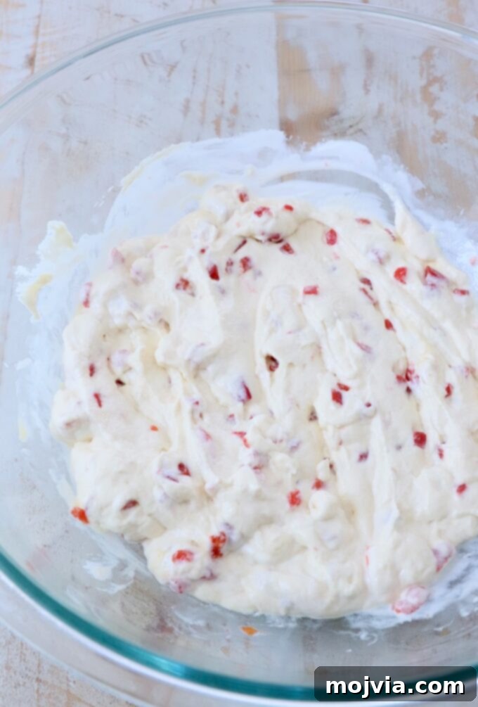 Golden Cheesy Squash Bake 8 The creamy mixture of sour cream, pimentos, and cream of chicken soup, thoroughly stirred together in a glass bowl.