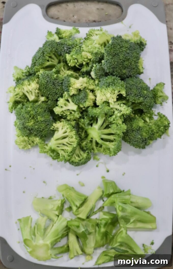 Vibrant Broccoli Slaw 4 Broccoli florets and stems separated on a cutting board, ready for preparation.