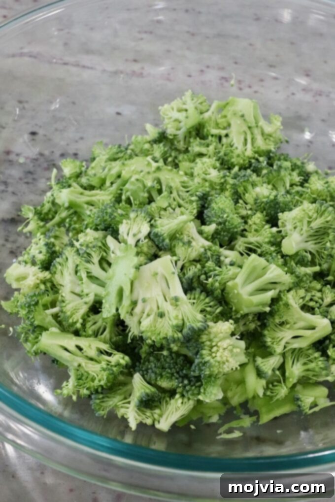 Vibrant Broccoli Slaw 7 Bowl containing neatly chopped broccoli florets, ready to be combined with other slaw ingredients.