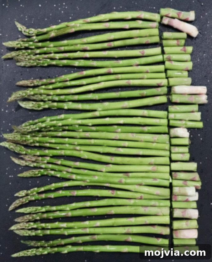 Simple Steps to Delicious Asparagus 3 Asparagus on a cutting board with woody ends removed, ready for cooking.