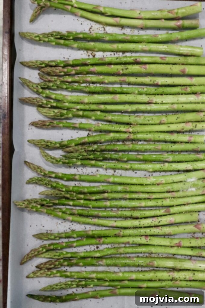 Simple Steps to Delicious Asparagus 7 Close-up of seasoned asparagus, glistening with olive oil and spices.