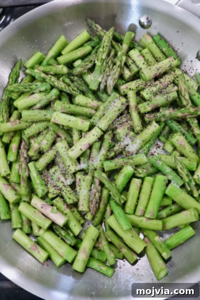 Simple Steps to Delicious Asparagus 10 Diced and seasoned asparagus cooking in a hot skillet on the stovetop.