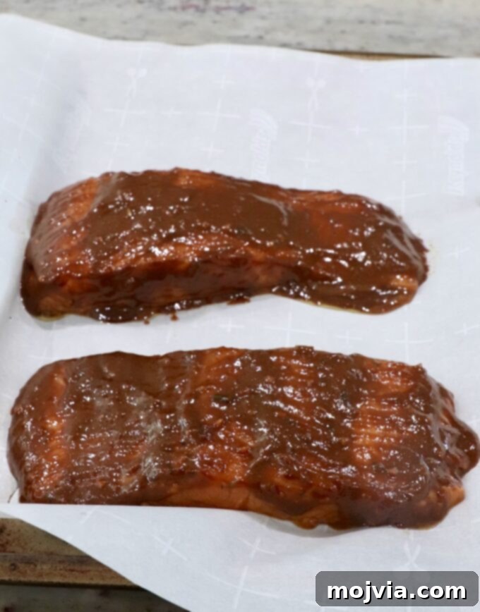 glazed salmon on parchment lined baking sheet