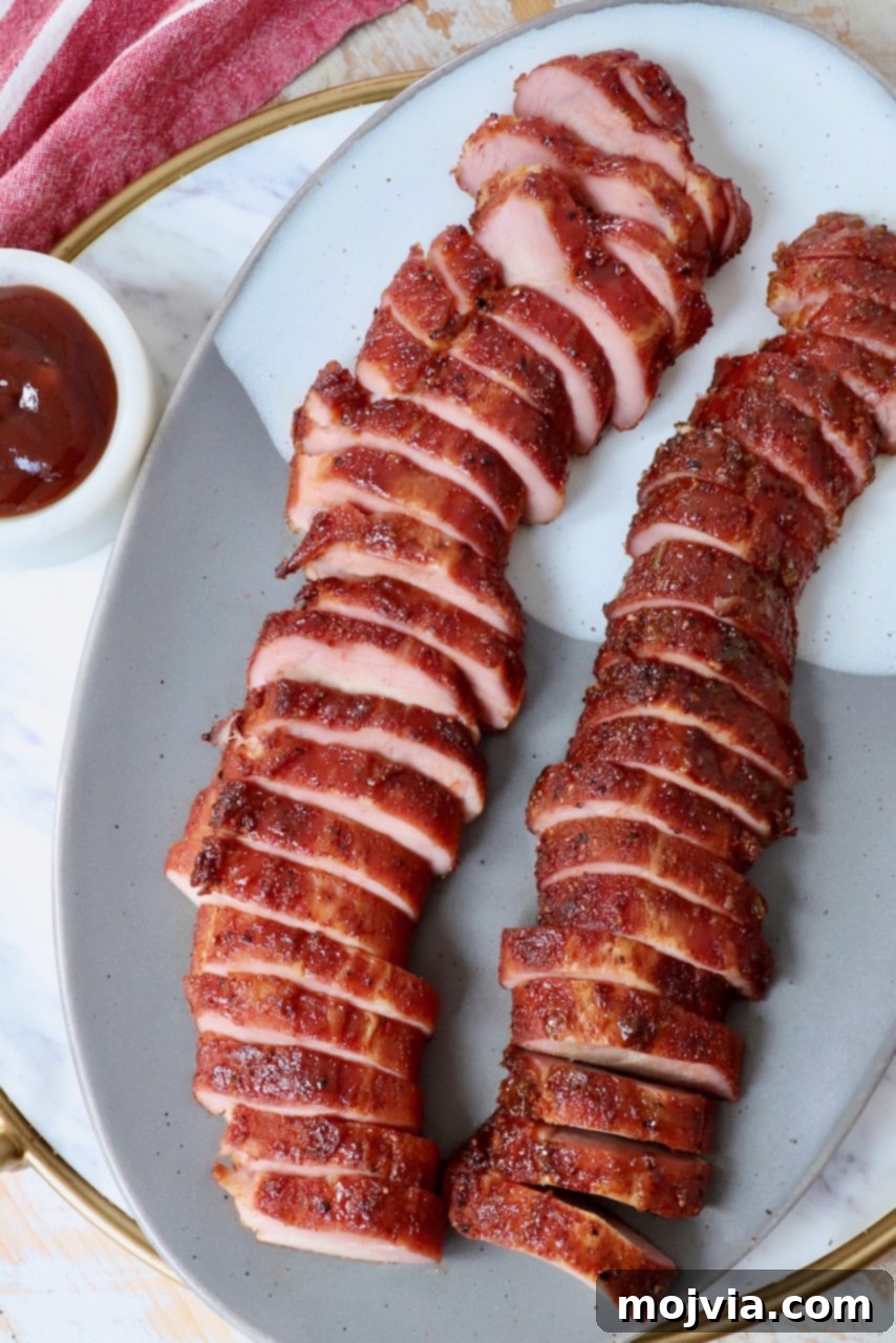 Perfectly Smoked Pork Tenderloin 2 smoked pork tenderloin sliced on plate