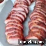 Perfectly Smoked Pork Tenderloin 10 sliced pork tenderloin on plate