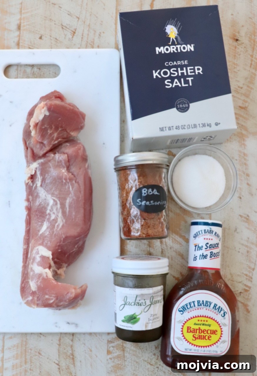 Perfectly Smoked Pork Tenderloin 3 ingredients for smoked pork tenderloin on white wood board