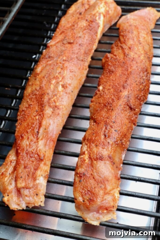 Perfectly Smoked Pork Tenderloin 5 seasoned pork tenderloins on smoker