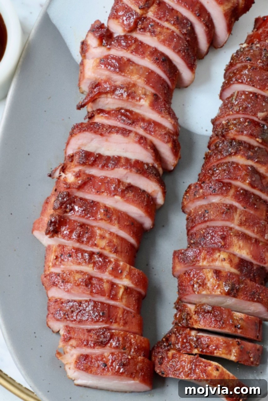 Perfectly Smoked Pork Tenderloin 8 smoked pork tenderloin sliced on plate