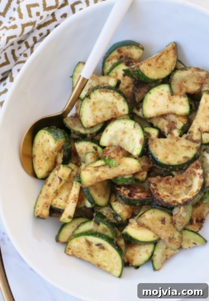 Mastering Zucchini: Your Essential Cooking Guide 11 cooked sliced zucchini in bowl with serving spoon