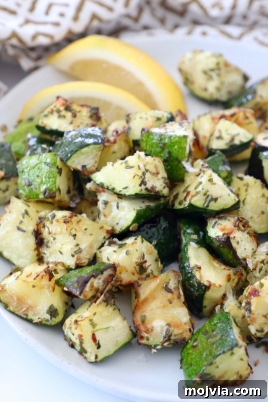 Mastering Zucchini: Your Essential Cooking Guide 17 diced cooked zucchini on plate with lemon wedges