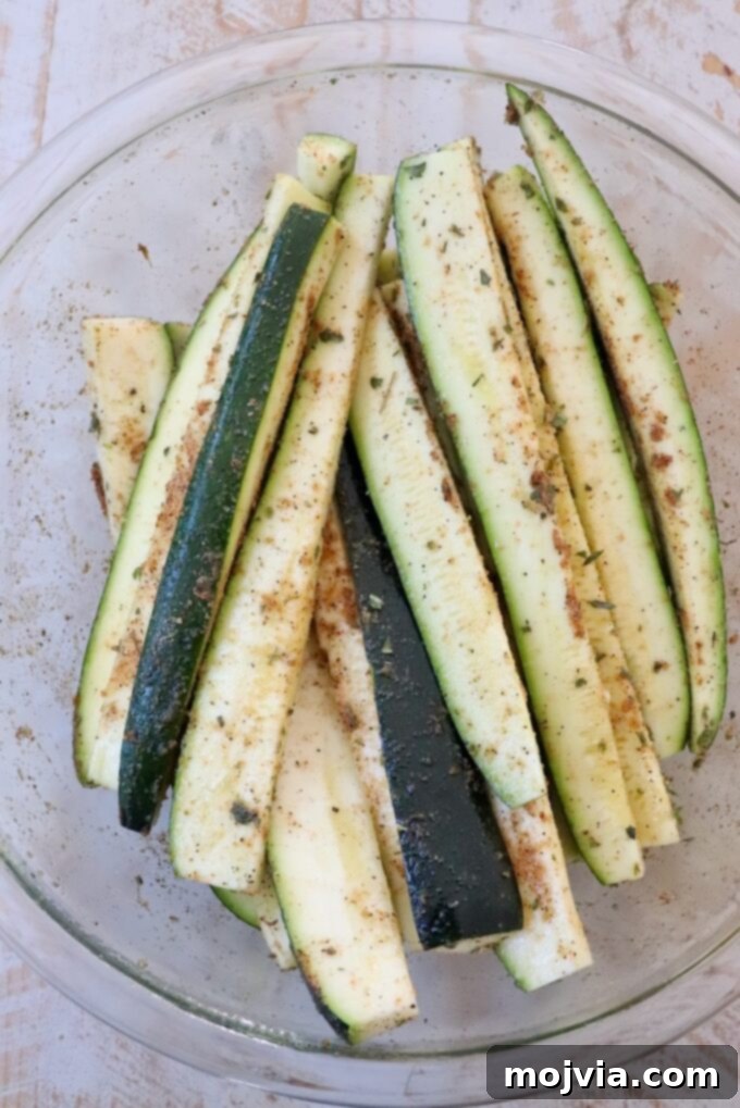 Mastering Zucchini: Your Essential Cooking Guide 3 seasoned zucchini spears in large glass bowl