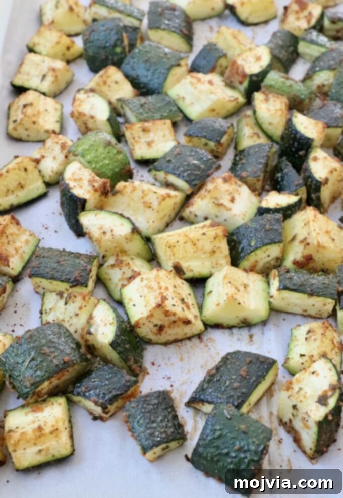Mastering Zucchini: Your Essential Cooking Guide 8 cooked diced zucchini on parchment lined baking sheet