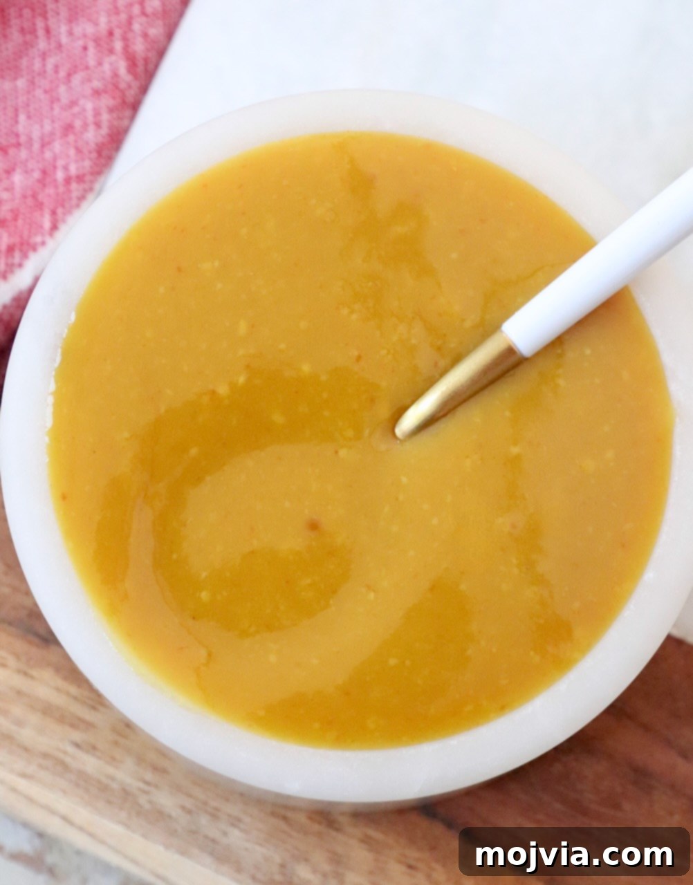 Carolina Gold Mustard Magic 2 mustard bbq sauce in bowl with spoon