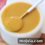 Carolina gold bbq sauce in small bowl with spoon