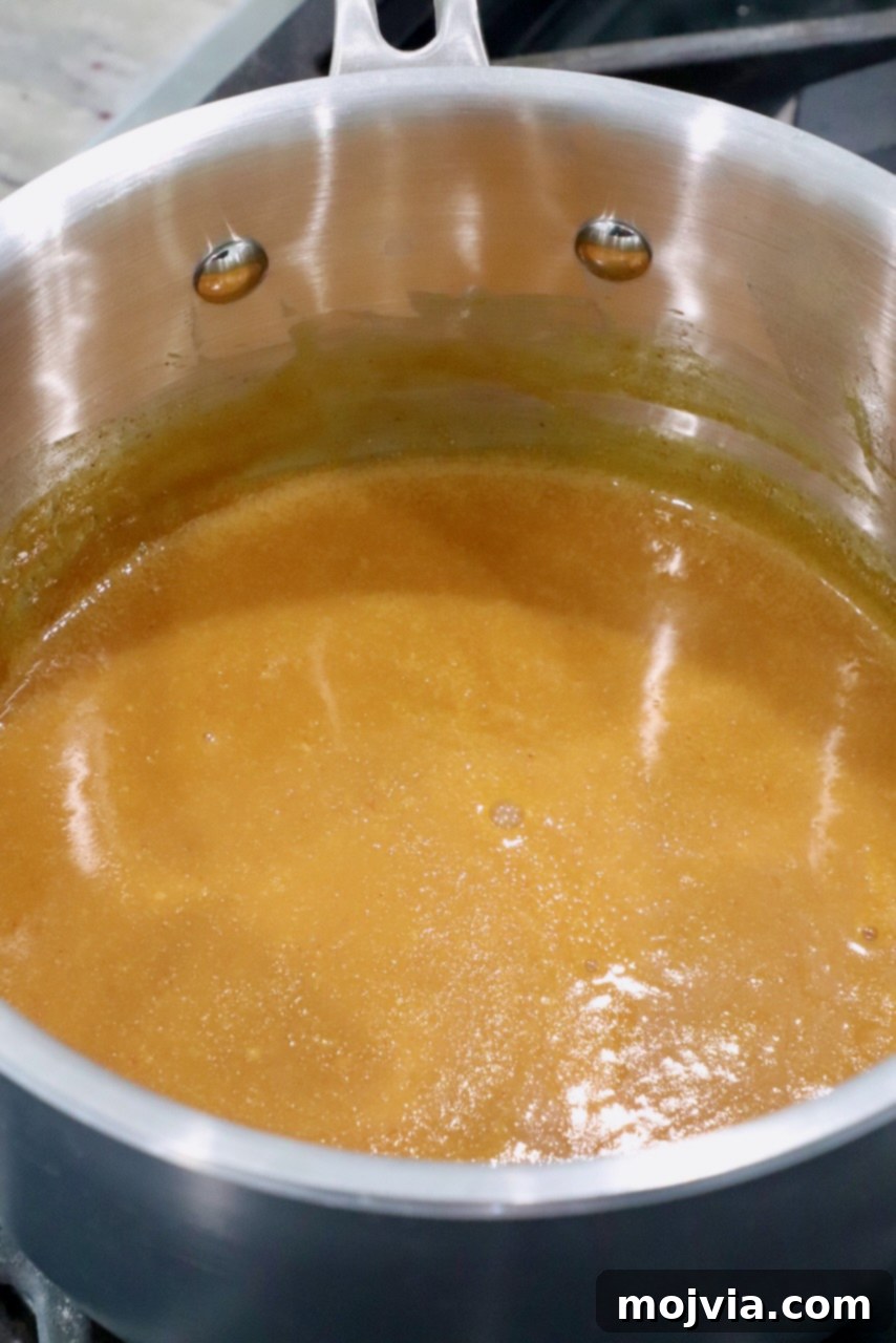 Carolina Gold Mustard Magic 4 mustard bbq sauce in pot on the stove