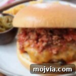 Robust Chili Burger 12 Chili cheeseburger on a plate, ready to be enjoyed.