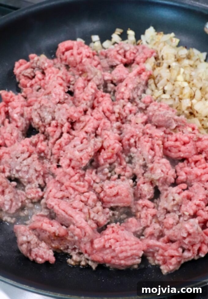 Robust Chili Burger 4 Ground beef, diced onions, and minced garlic in a large skillet, ready to cook for chili.