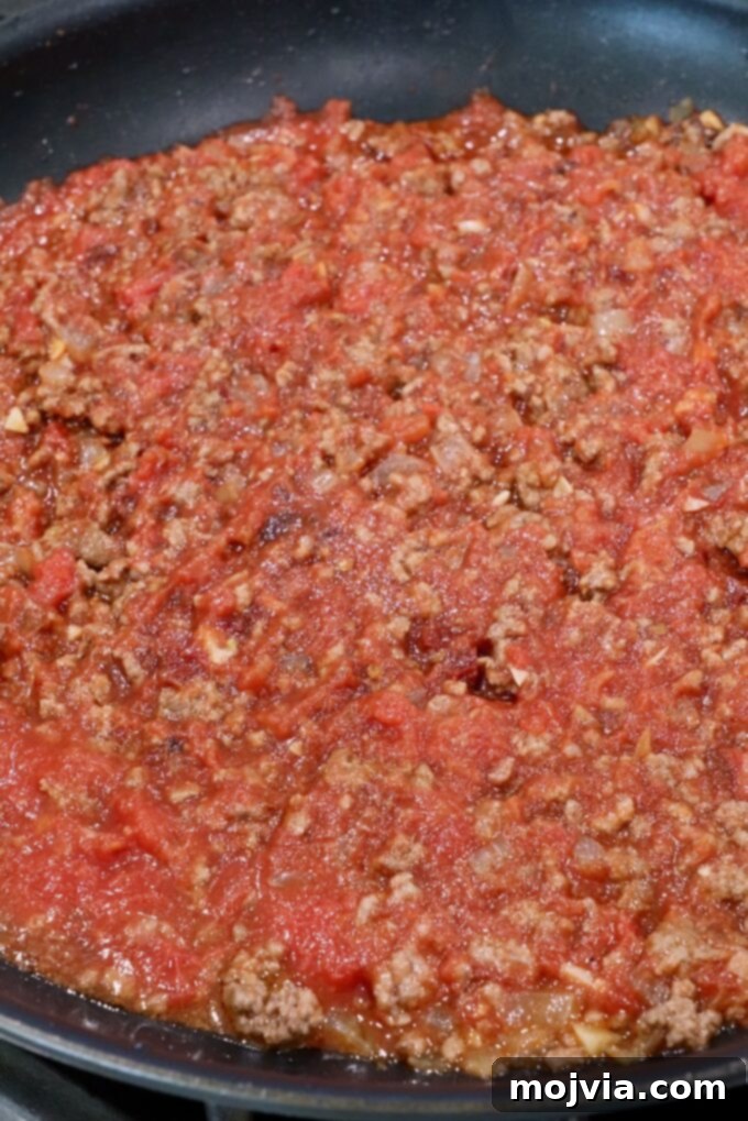 Robust Chili Burger 7 Perfectly prepared chili sauce simmering in a skillet, ready to be served over burgers.