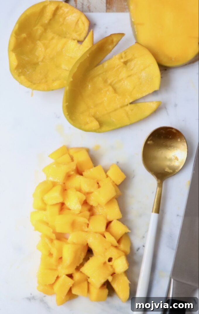 The Art of Mango Slicing 8 Pile of freshly diced mango on a cutting board, ready for use in recipes