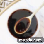 Umami Glaze 8 teriyaki sauce in small bowl with spoon