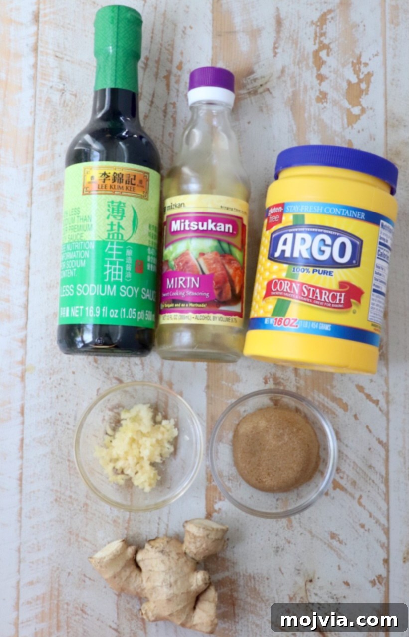 Umami Glaze 3 Fresh ingredients for homemade teriyaki sauce laid out on a clean white wooden board: soy sauce, mirin, brown sugar, whole garlic cloves, and a knob of fresh ginger.