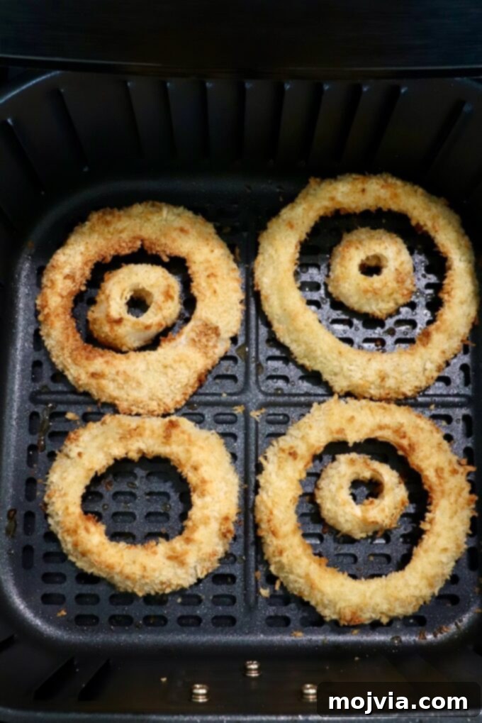 Golden & Crispy Air Fryer Onion Rings 11 cooked, golden onion rings fresh out of the air fryer basket