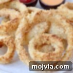 Golden & Crispy Air Fryer Onion Rings 14 cooked onion rings on plate
