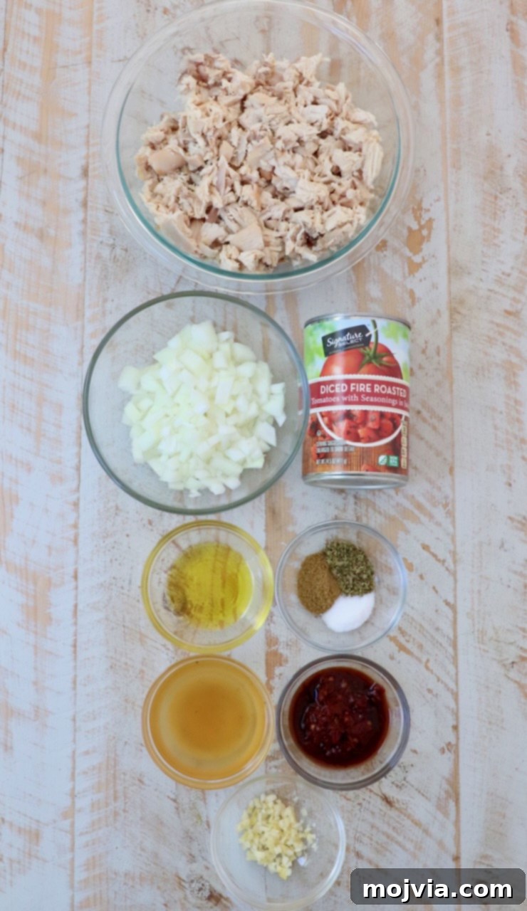 Smoky Chipotle Chicken Tinga 3 ingredients for chicken tinga on white wood board