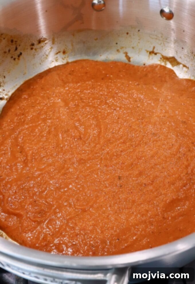 Smoky Chipotle Chicken Tinga 6 tinga sauce in pan on the stove