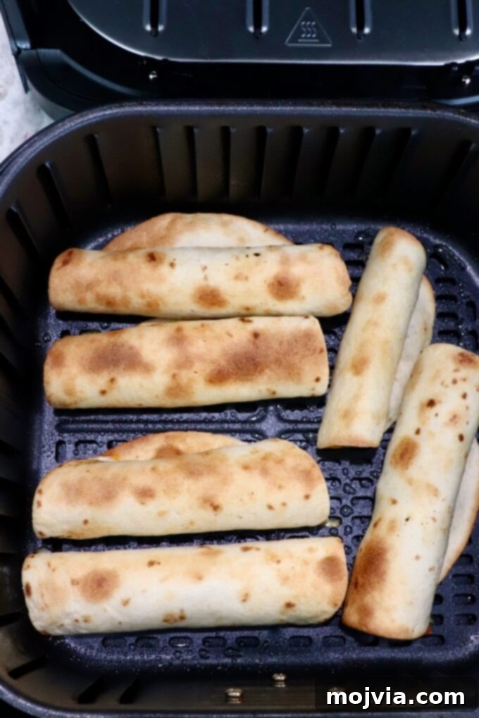 Crispy Beef Taquitos 9 cooked taquitos in air fryer basket