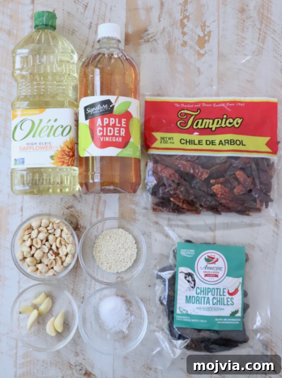Salsa Macha 3 ingredients for salsa macha on a white wood board