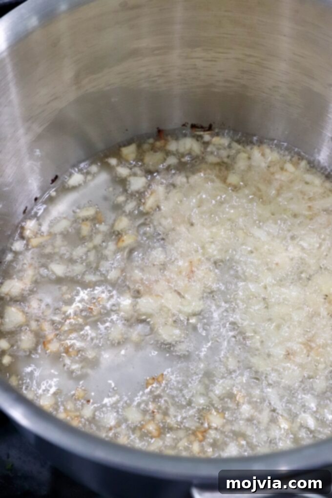 Salsa Macha 6 garlic cooking in oil in a saucepan