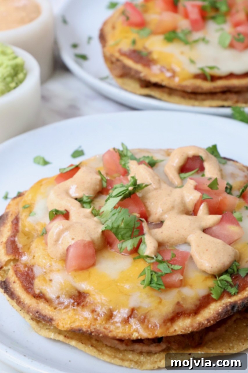 Mexican pizza topped with creamy jalapeno sauce on a plate