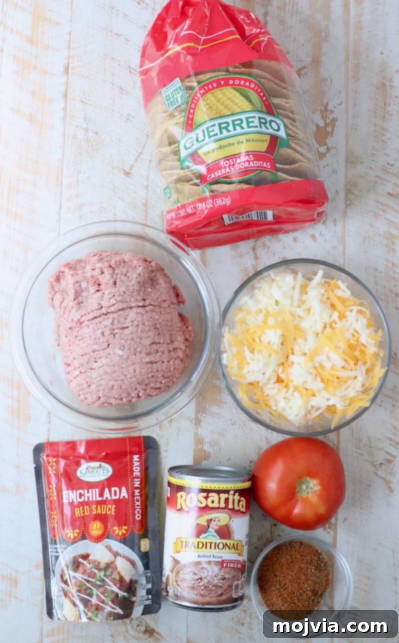 ingredients for Mexican pizza on white wood board
