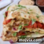 Golden Grilled Chicken Quesadillas 13 sliced quesadilla stacked up on a plate