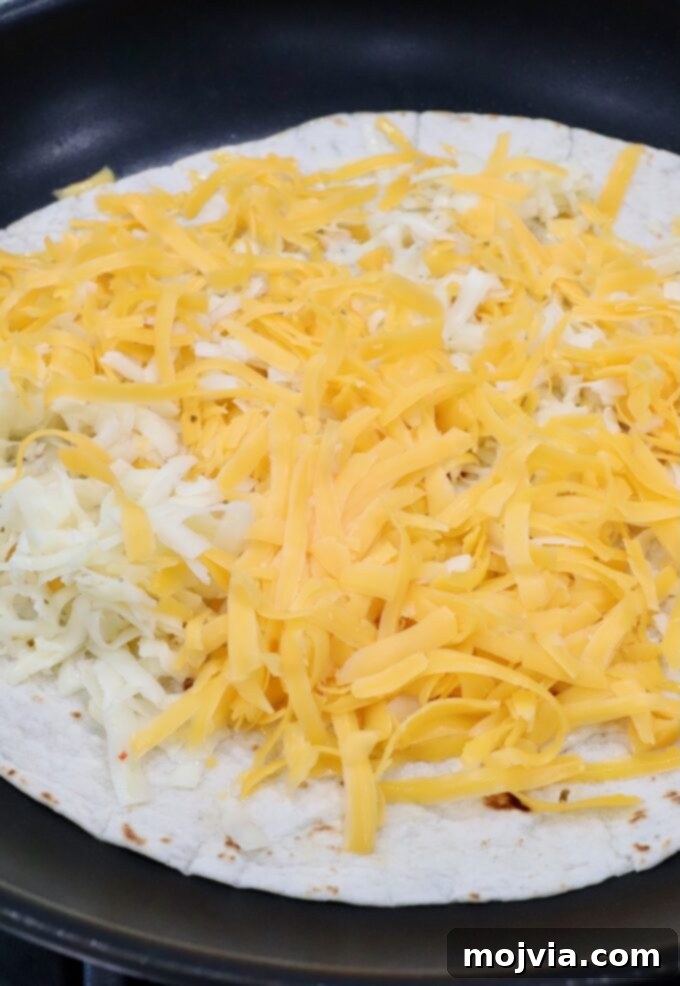 Golden Grilled Chicken Quesadillas 7 shredded cheese on tortilla in skillet