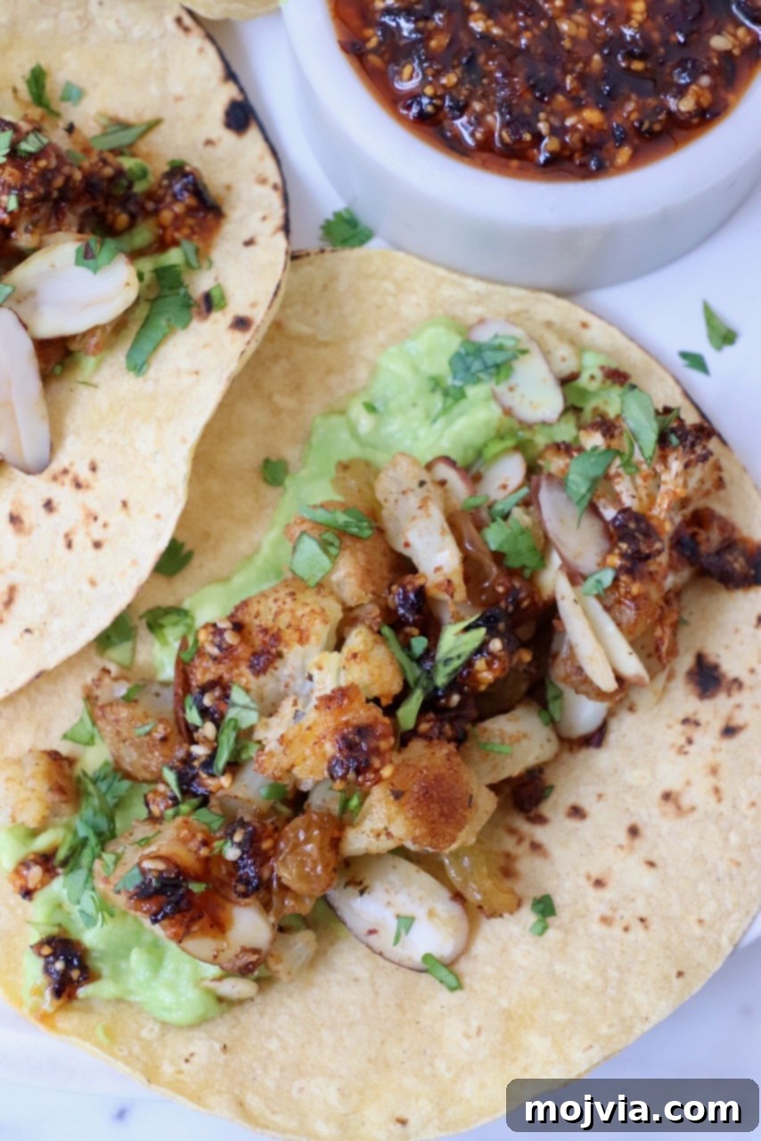 Spicy Cauliflower Tacos 2 Crispy roasted cauliflower tacos with fresh salsa on a plate