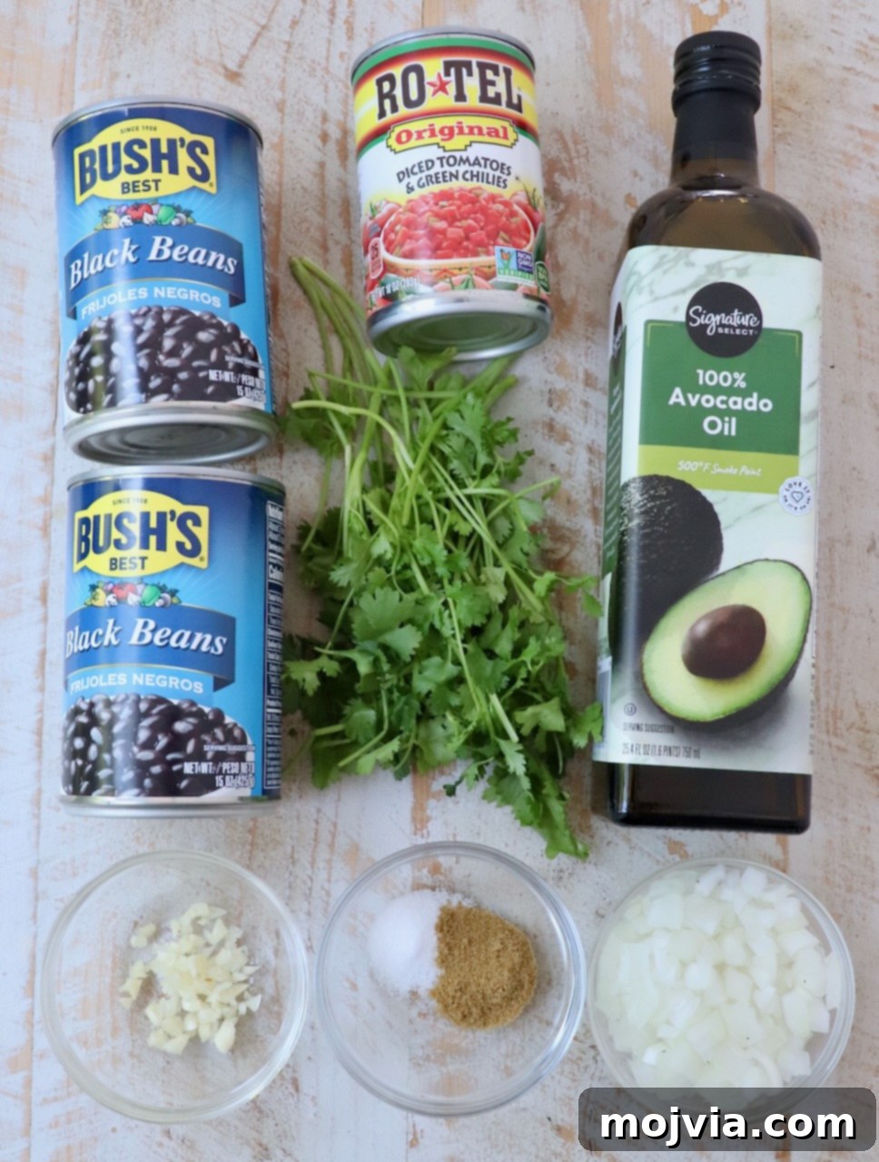 Traditional Mexican Black Beans 3 ingredients for Mexican black beans on white wood board