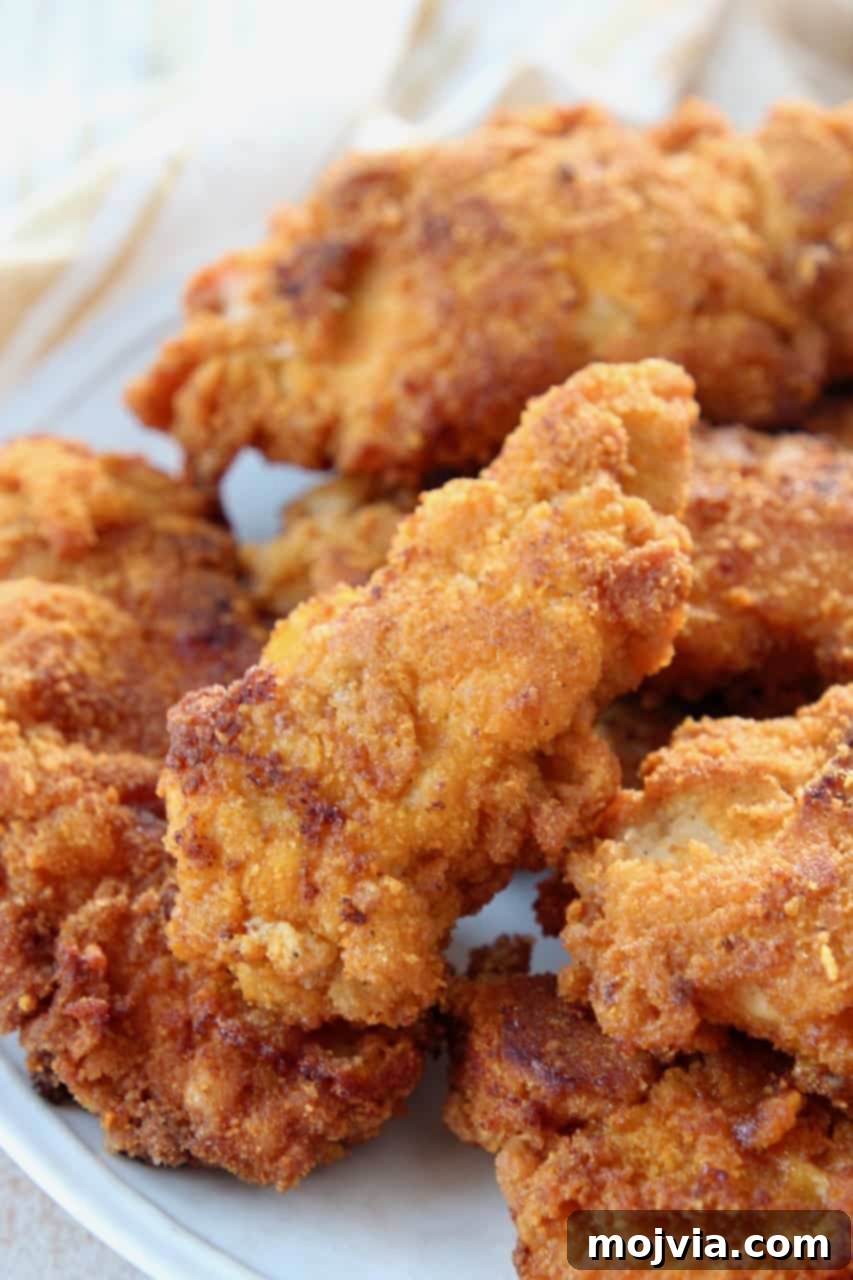 Dads Signature Captain Crunch Chicken Tenders 4 Crispy Captain Crunch fried chicken tenders stacked high on a plate, ready to be served.